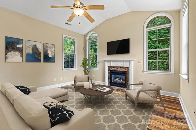 a living room with furniture fireplace and window