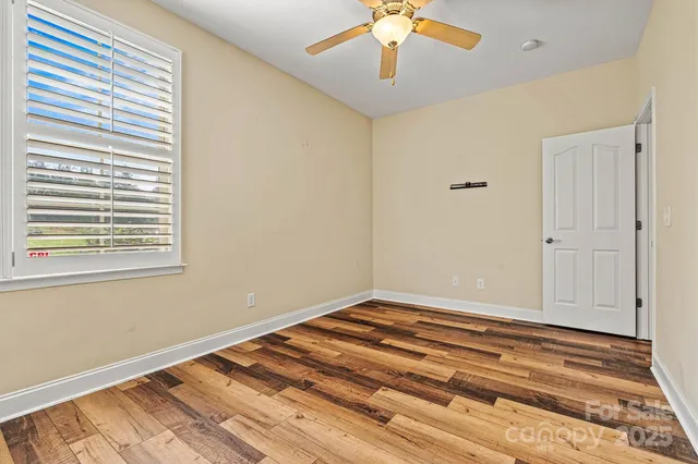 a view of a room with a ceiling fan