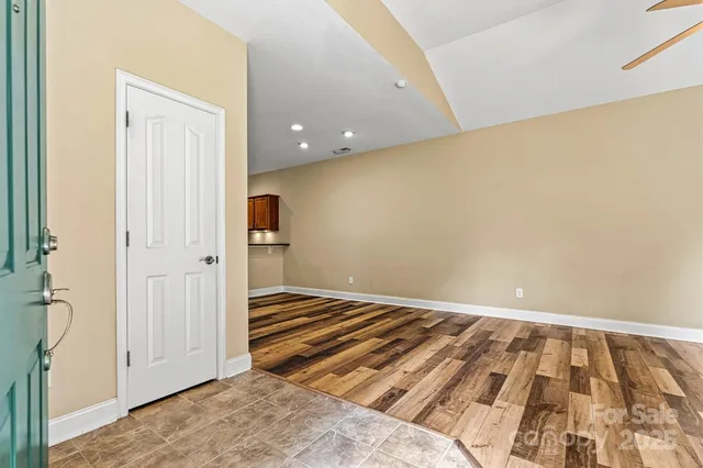 a view of a room with wooden floor and white walls