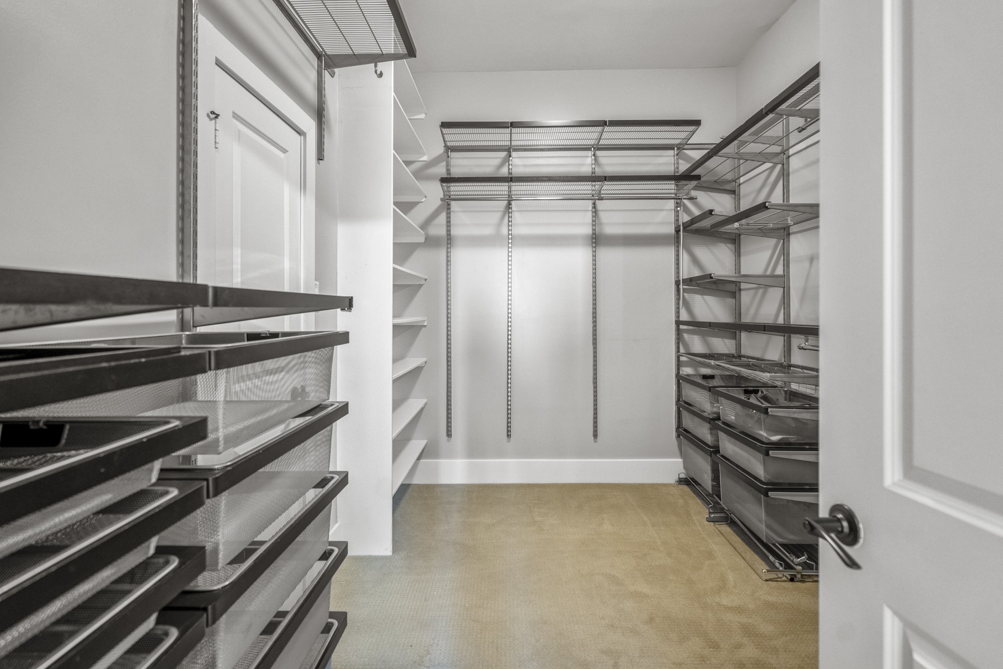 1310 West Dallas Street Houston, TX 77019 - Photo 34 of 50 Just off the primary bath, the walk-in closet is fully outfitted with custom shelving, hanging space, and pull-out storage—designed to keep everything organized and easy to access.