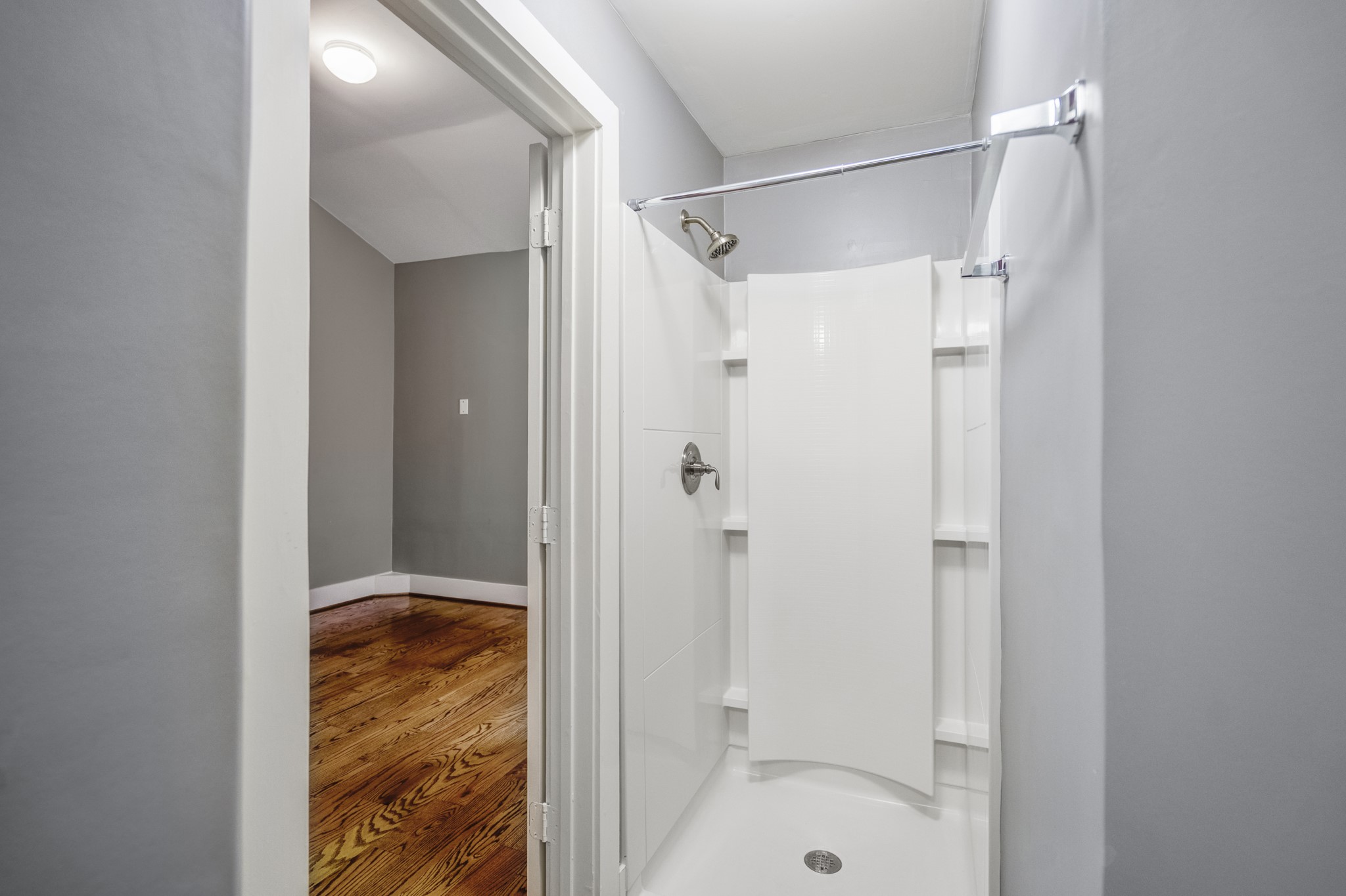 1310 West Dallas Street Houston, TX 77019 - Photo 42 of 50 Around the corner, the shower is bright and straightforward, with built-in shelving and a clean surround that keeps maintenance simple. Positioned within the bedroom’s private bath, it completes a self-contained suite that works equally well for guests or everyday living.
