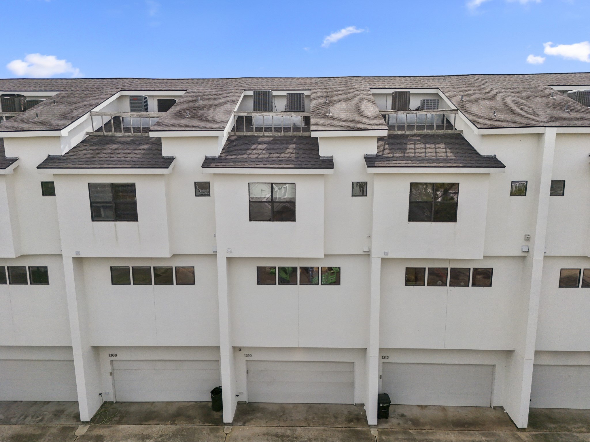 1310 West Dallas Street Houston, TX 77019 - Photo 46 of 50 An aerial look at the rear of the townhome reveals private garage access and a crisp, modern layout designed for effortless urban living.