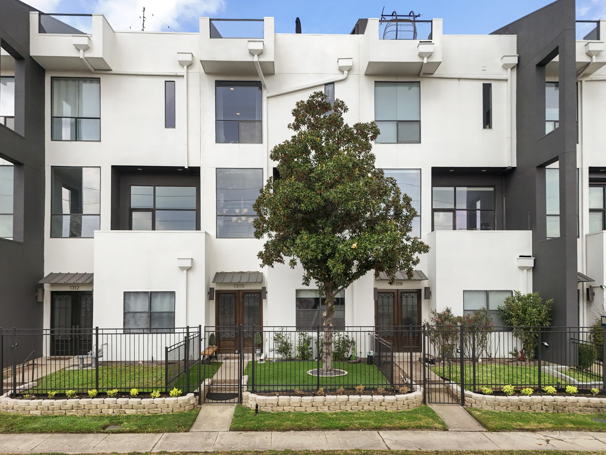 1310 West Dallas Street Houston, TX 77019 - Photo 50 of 50 Our "Last Look" at this modern townhome with a private, fenced front yard—clean architectural lines, thoughtful landscaping, and a welcoming street presence in the heart of the community.
