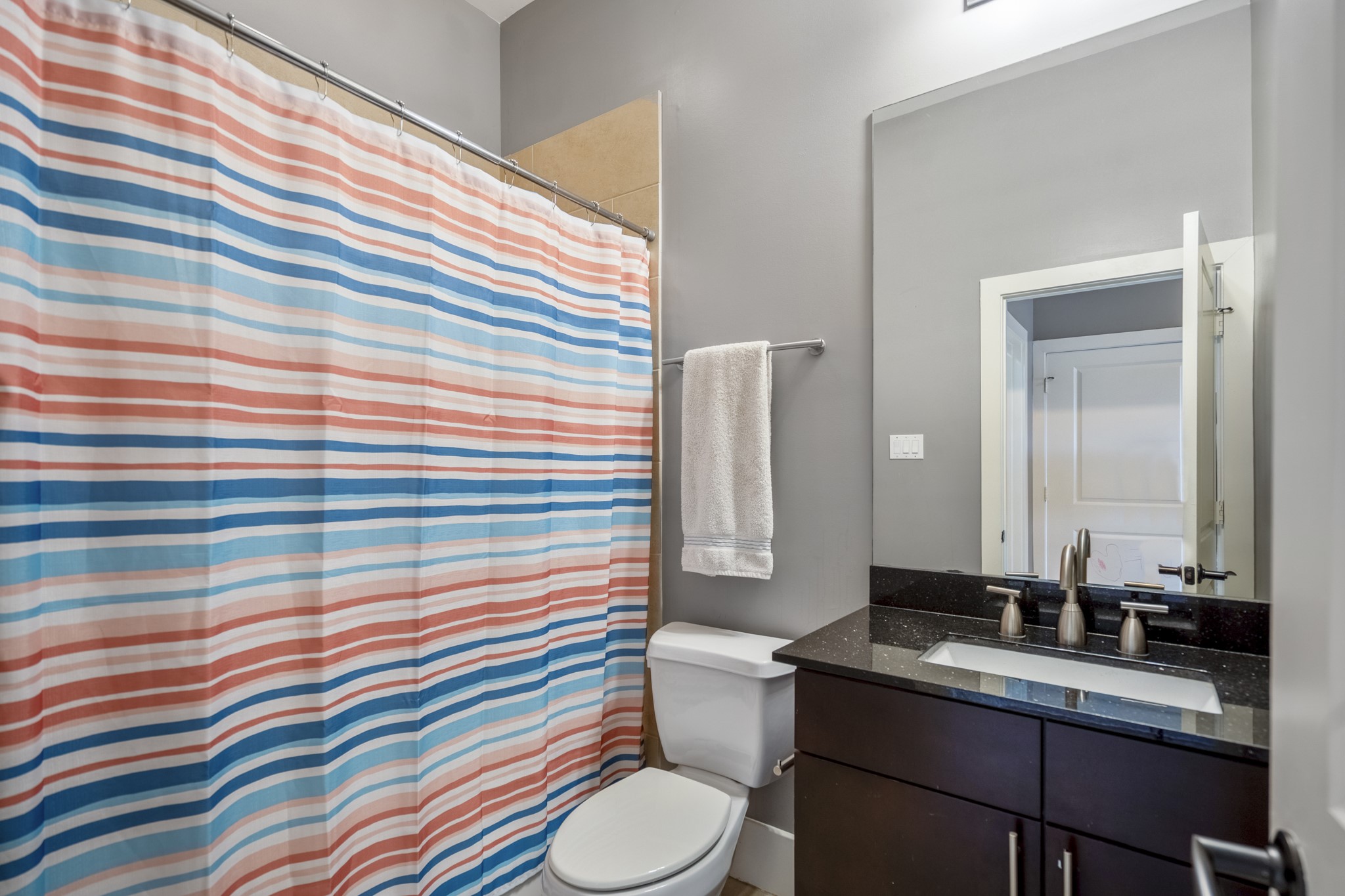 1310 West Dallas Street Houston, TX 77019 - Photo 9 of 50 Located inside the first-floor bedroom, the en-suite bath features a clean vanity and walk-in shower.