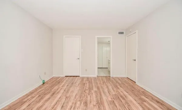 a view of a room with wooden floor and closet