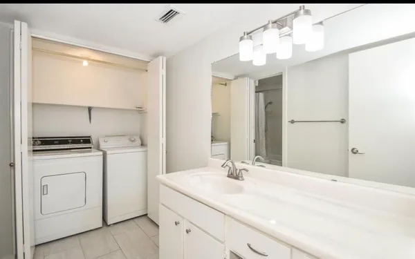 a bathroom with a sink vanity and a mirror