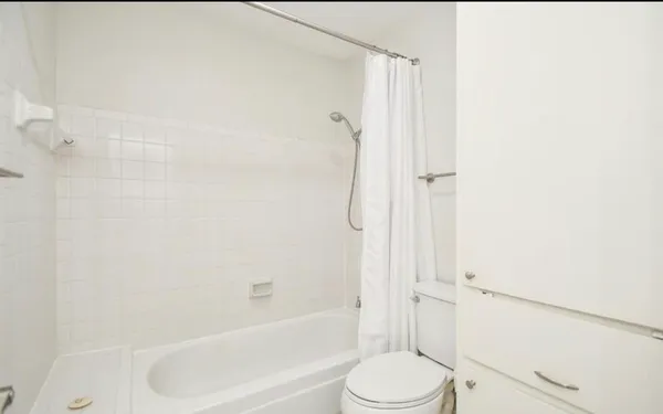 a bathroom with a toilet and shower
