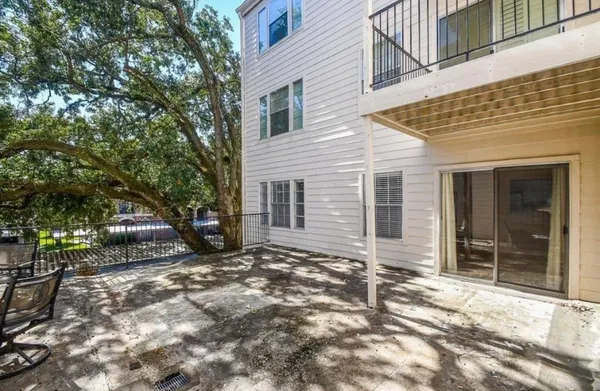 front view of a house with a large tree