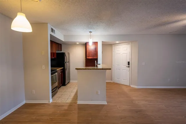 a view of a kitchen with cabinets and stainless steel appliances