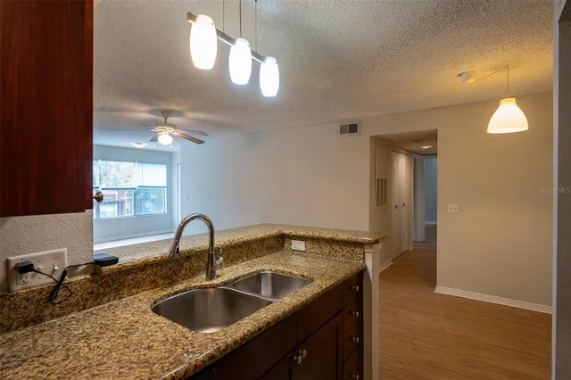 a kitchen with a sink and a mirror
