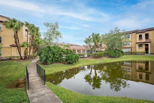a swimming pool with outdoor seating and garden