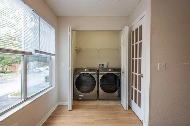 a view of a bedroom with washer and dryer