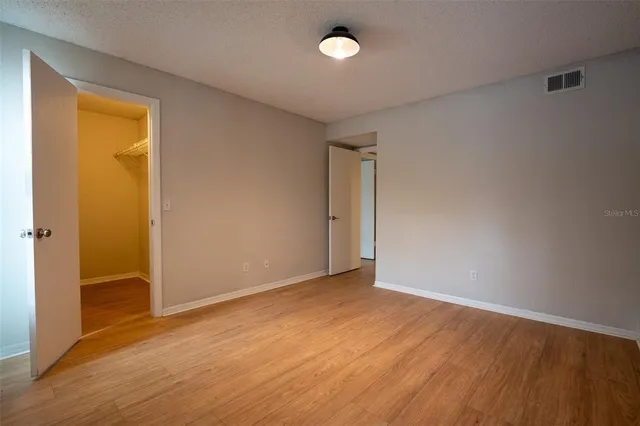 an empty room with wooden floor and a window