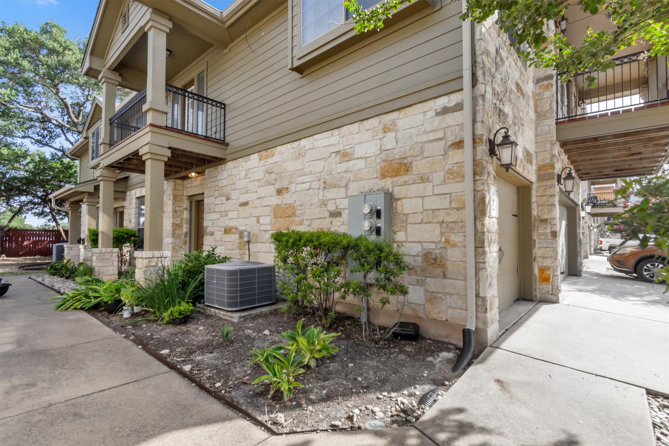 14815 Avery Ranch Boulevard, Unit 2A Austin, TX 78717 - Photo 24 of 27 A well-maintained multi-story structure featuring stone and siding construction, offering private balconies and integrated garages.