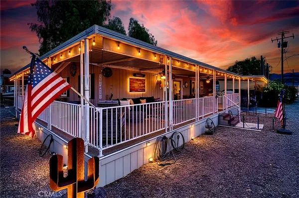 a view of house with backyard and porch