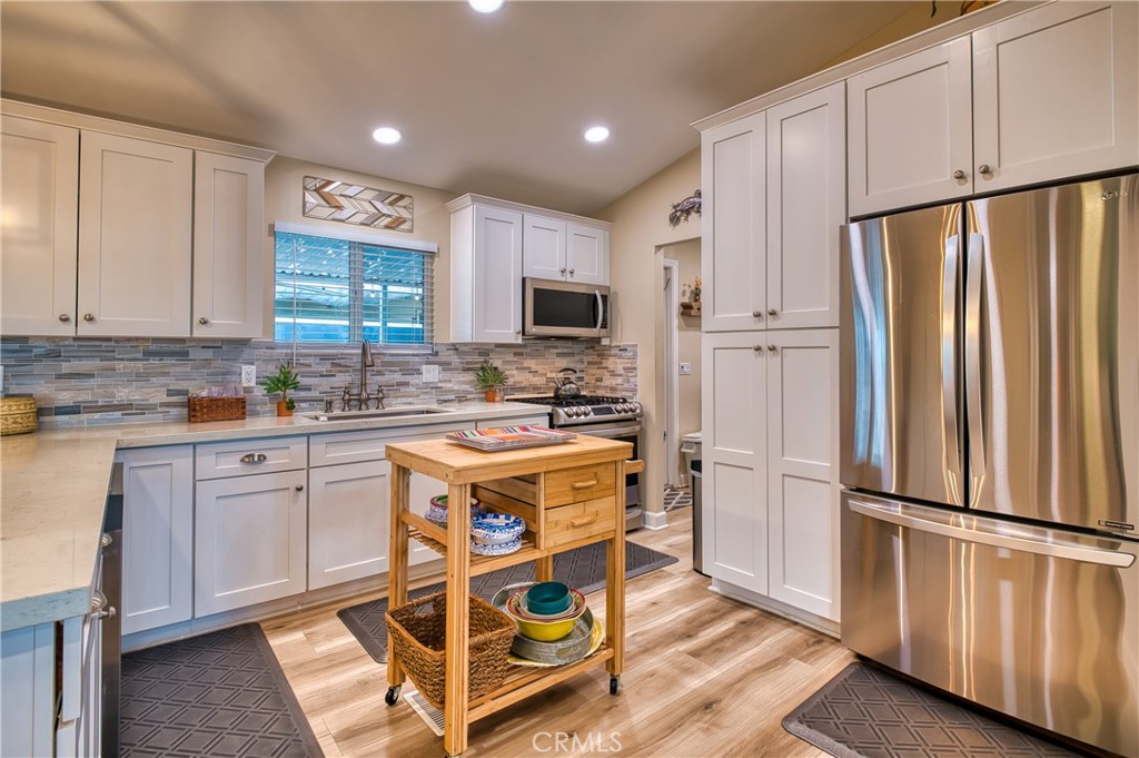 2054 Parker Dam Road, Unit E8 Earp, CA 92242 - Photo 17 of 75 a kitchen with stainless steel appliances granite countertop a refrigerator stove microwave and sink