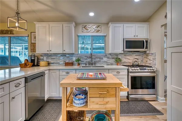 a kitchen with a stove a refrigerator and a sink