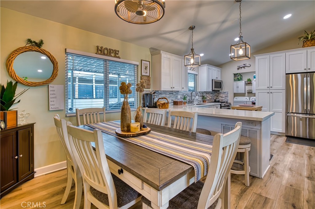 2054 Parker Dam Road, Unit E8 Earp, CA 92242 - Photo 26 of 75 a view of a dining room with furniture a chandelier and wooden floor