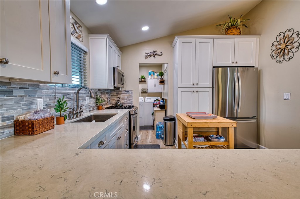 2054 Parker Dam Road, Unit E8 Earp, CA 92242 - Photo 31 of 75 a kitchen that has a lot of cabinets a sink and a refrigerator in it