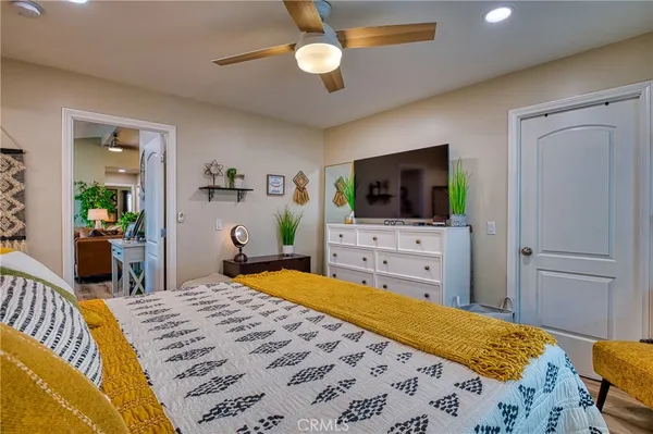 a bedroom with natural light and a bed