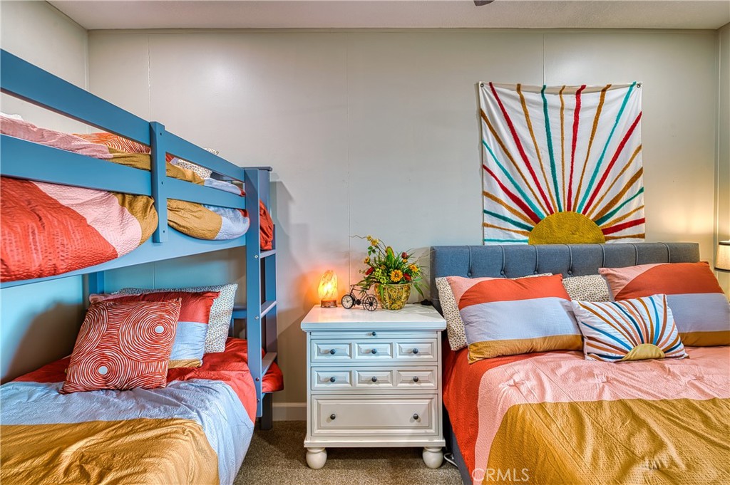 2054 Parker Dam Road, Unit E8 Earp, CA 92242 - Photo 44 of 75 a bedroom with a bed and a painting on the wall