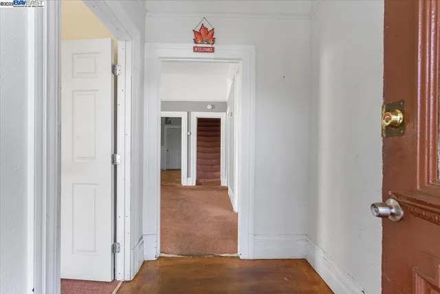 an empty room with a windows and chandelier