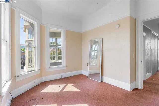 an empty room that has a wooden cupboard