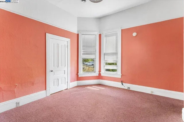 a view of a hallway with toilet and a window