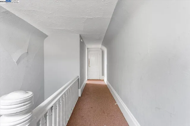 a view of a livingroom with furniture a flat screen tv and kitchen view