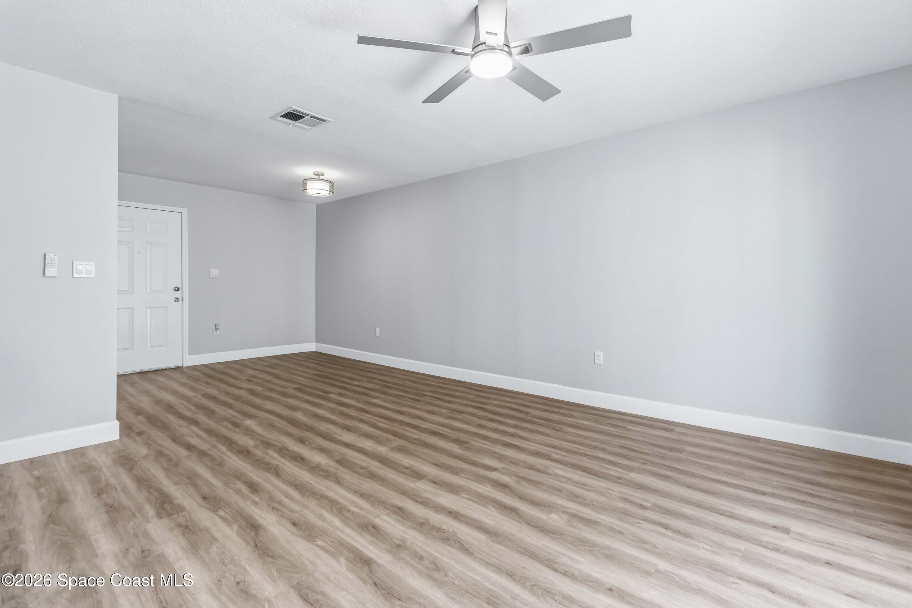2258 Flower Tree Circle Melbourne, FL 32935 - Photo 16 of 30 wooden floor in an empty room