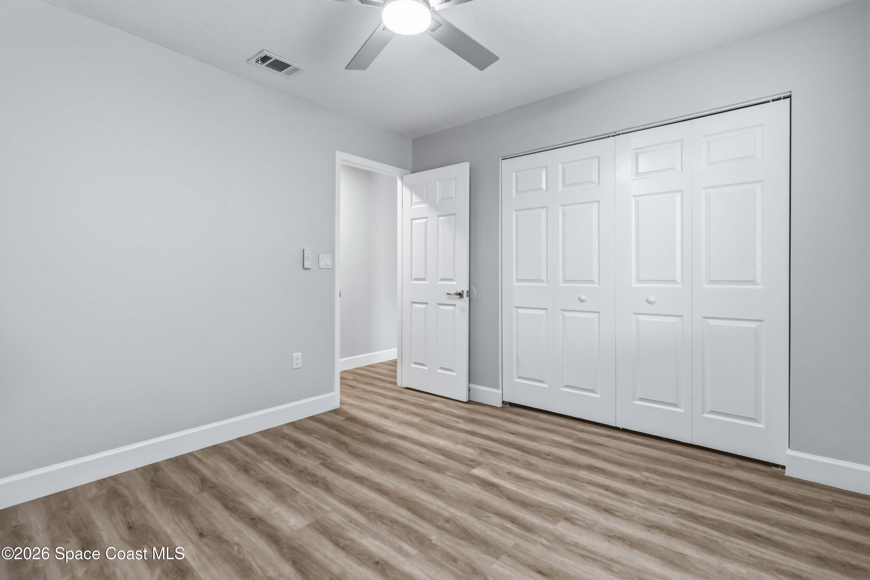 2258 Flower Tree Circle Melbourne, FL 32935 - Photo 17 of 30 wooden floor in an empty room