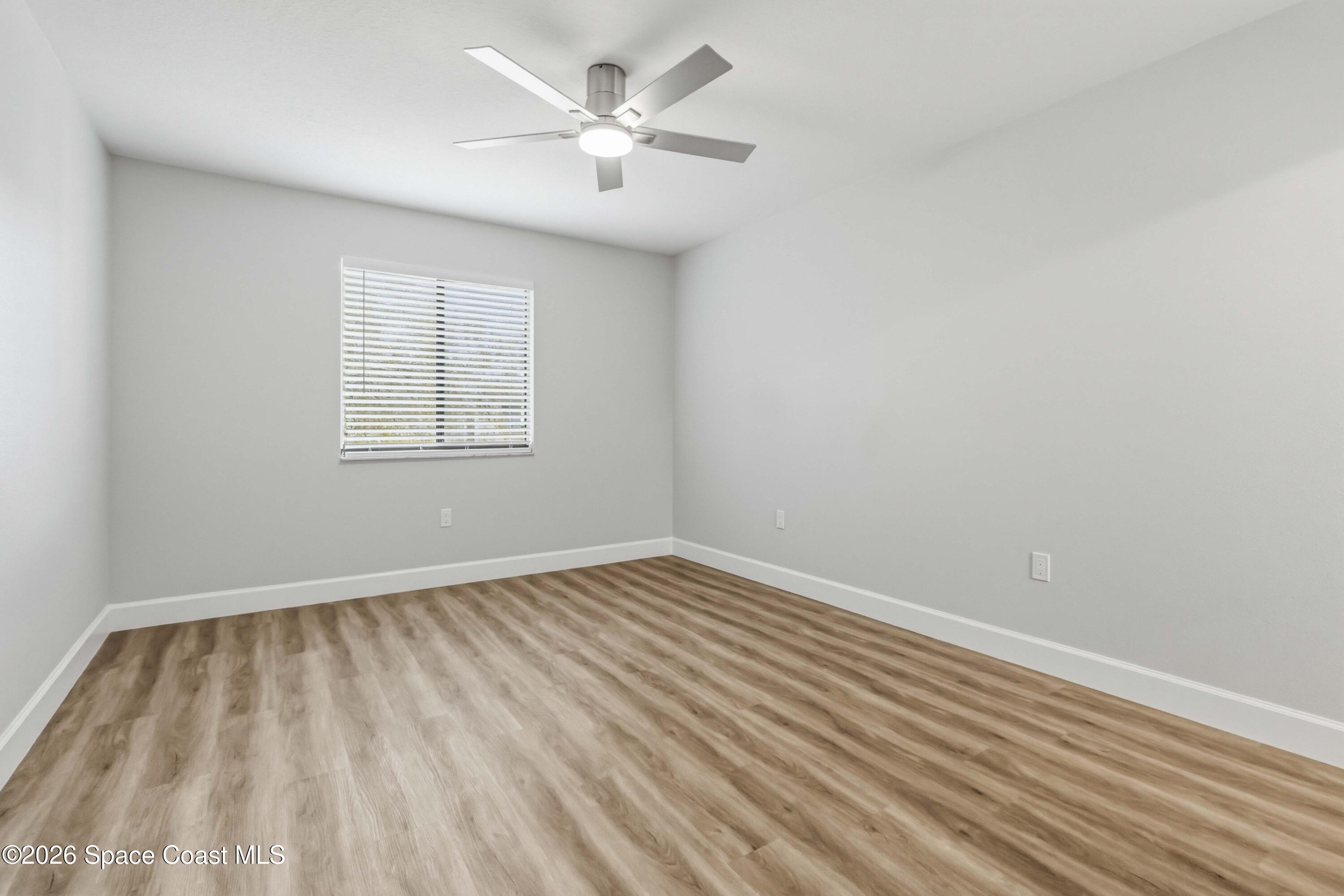 2258 Flower Tree Circle Melbourne, FL 32935 - Photo 19 of 30 wooden floor in an empty room with a window