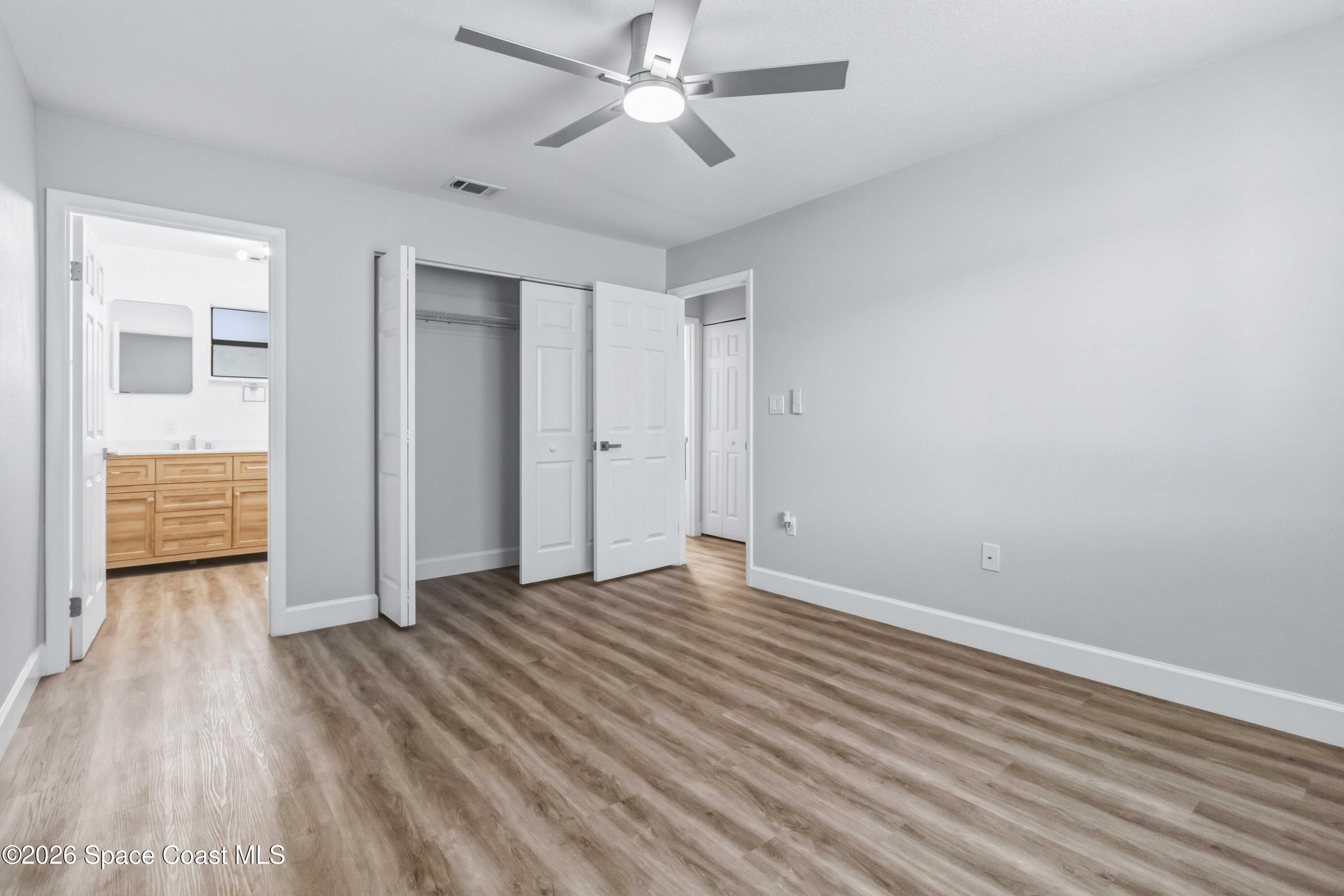 2258 Flower Tree Circle Melbourne, FL 32935 - Photo 20 of 30 wooden floor in an empty room with a window