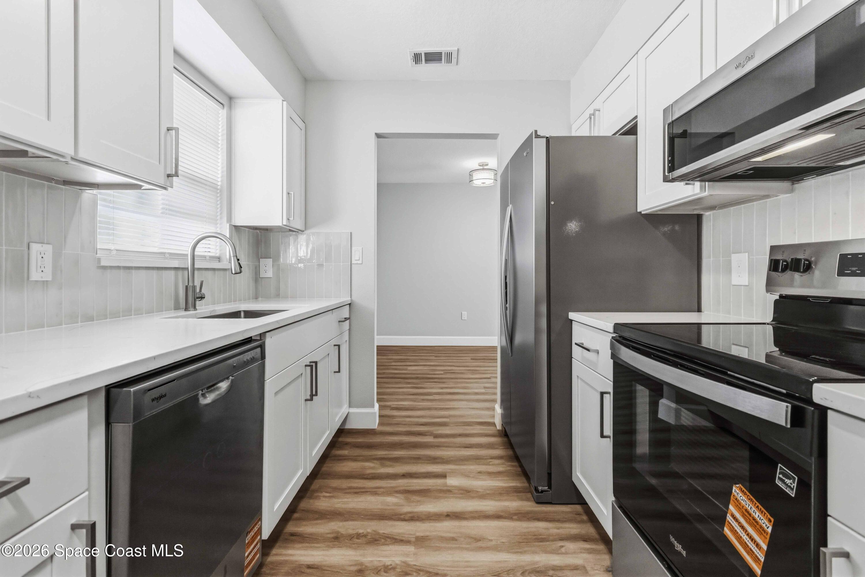 2258 Flower Tree Circle Melbourne, FL 32935 - Photo 2 of 30 a kitchen with a sink and stainless steel appliances