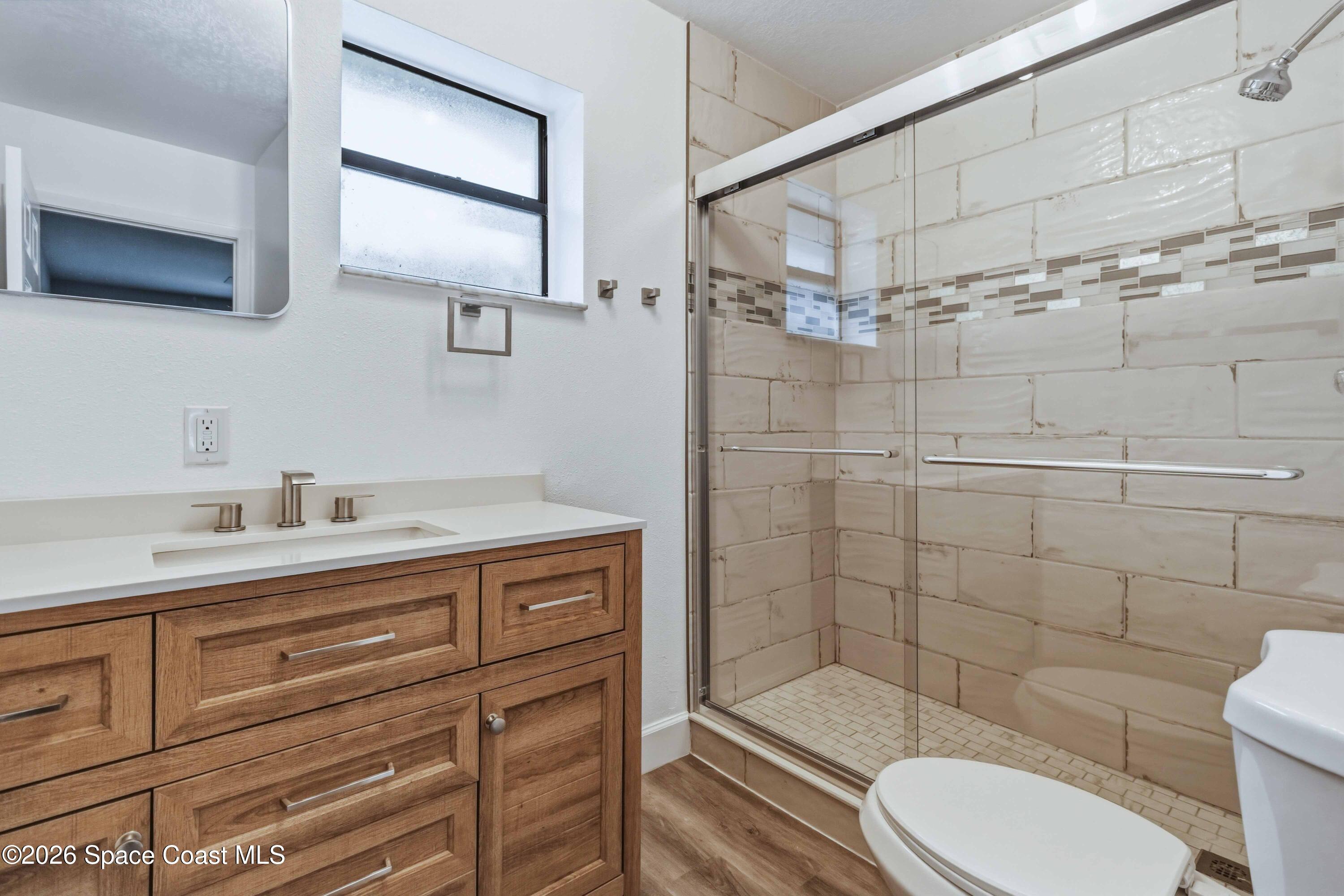 2258 Flower Tree Circle Melbourne, FL 32935 - Photo 21 of 30 a bathroom with a sink a toilet and shower