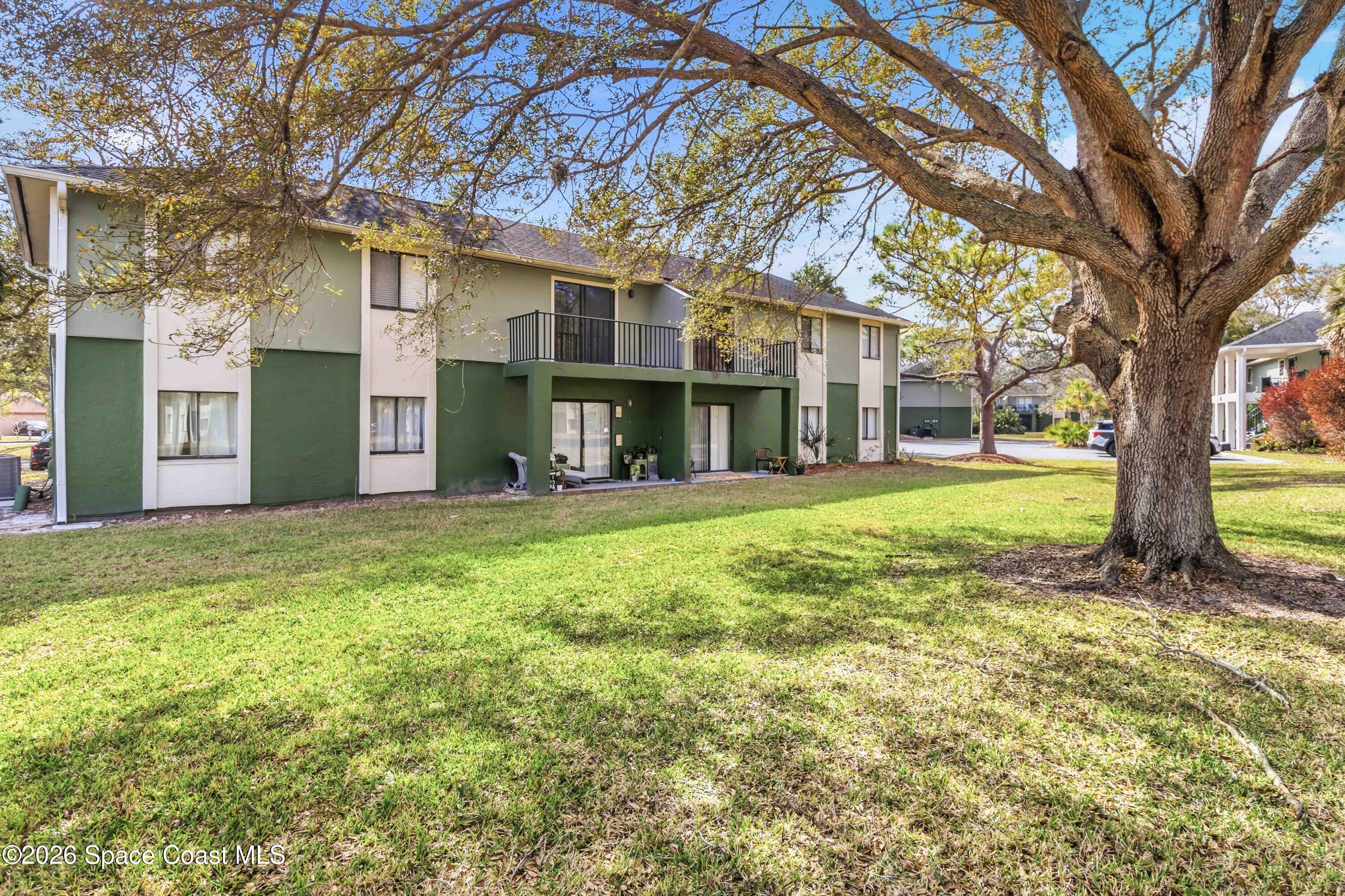 2258 Flower Tree Circle Melbourne, FL 32935 - Photo 25 of 30 a view of a yard in front of a building
