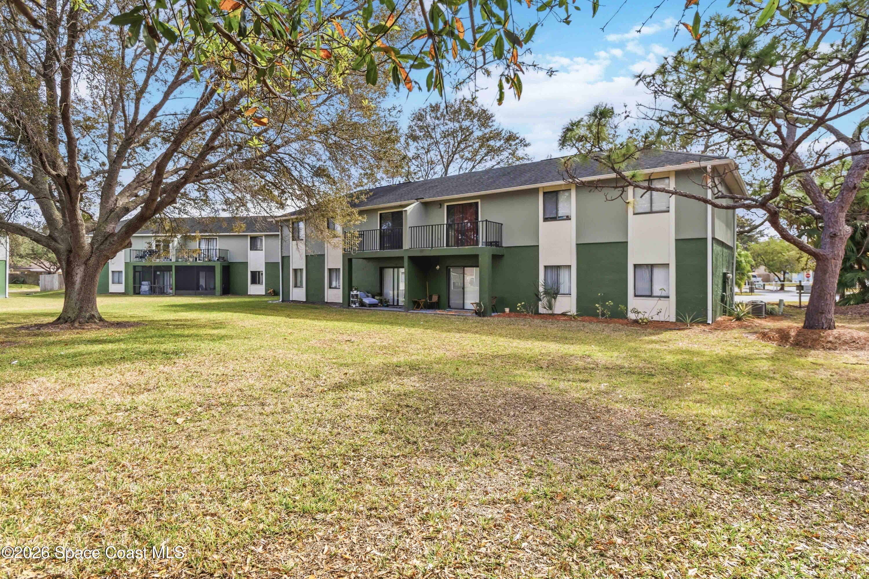 2258 Flower Tree Circle Melbourne, FL 32935 - Photo 26 of 30 a view of a house with a yard