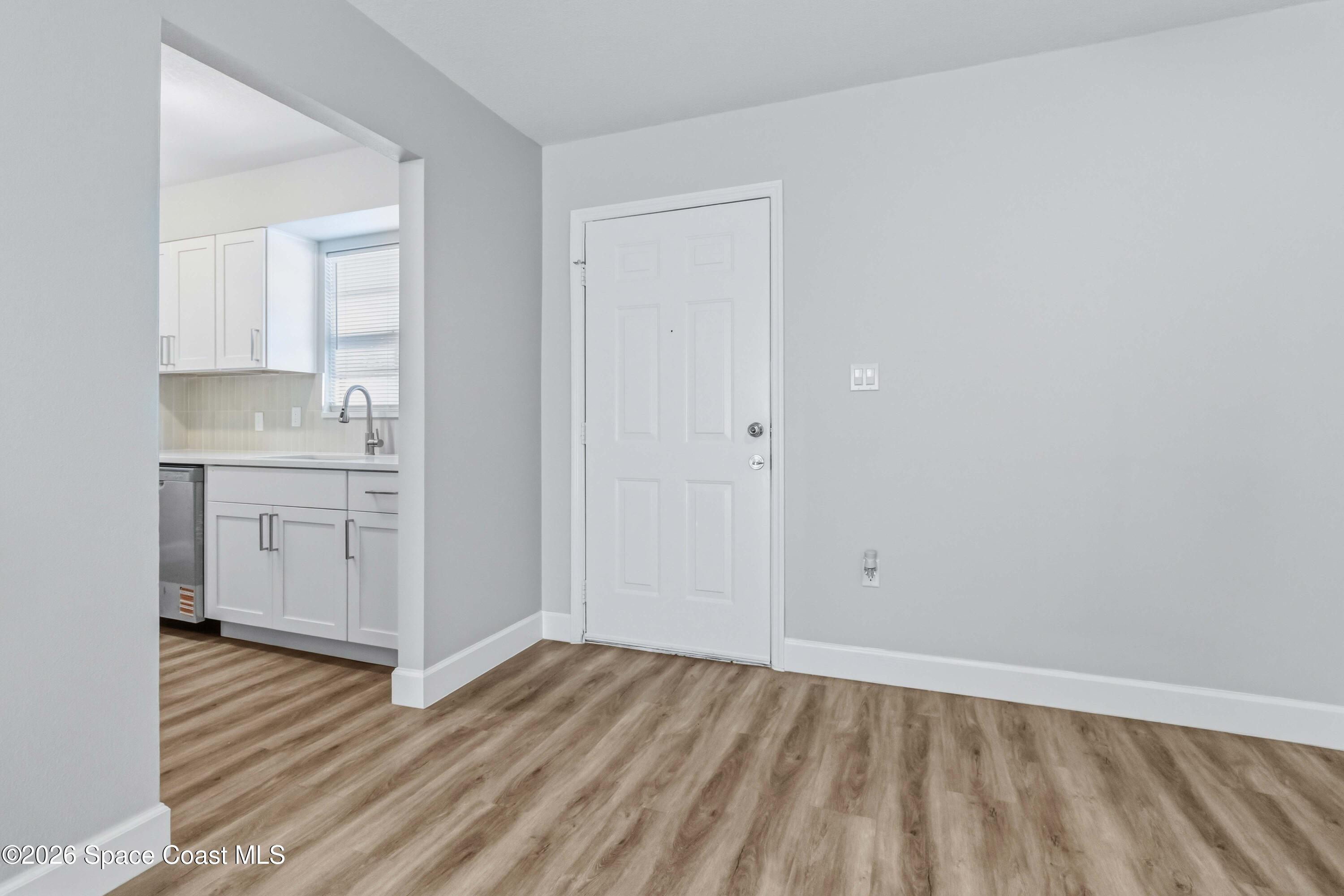 2258 Flower Tree Circle Melbourne, FL 32935 - Photo 3 of 30 a view of a kitchen with wooden floor and a sink