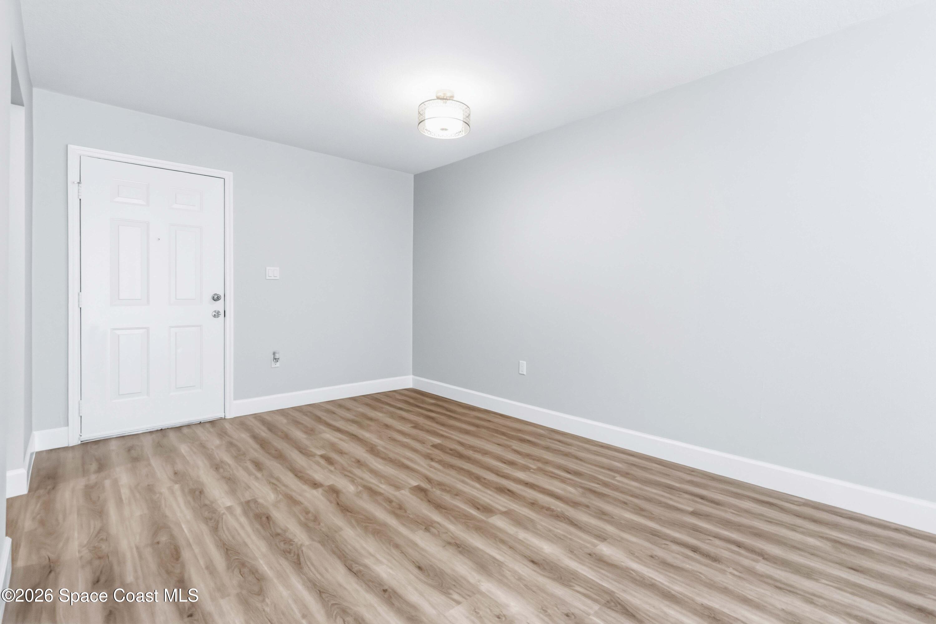 2258 Flower Tree Circle Melbourne, FL 32935 - Photo 8 of 30 a view of an empty room with wooden floor