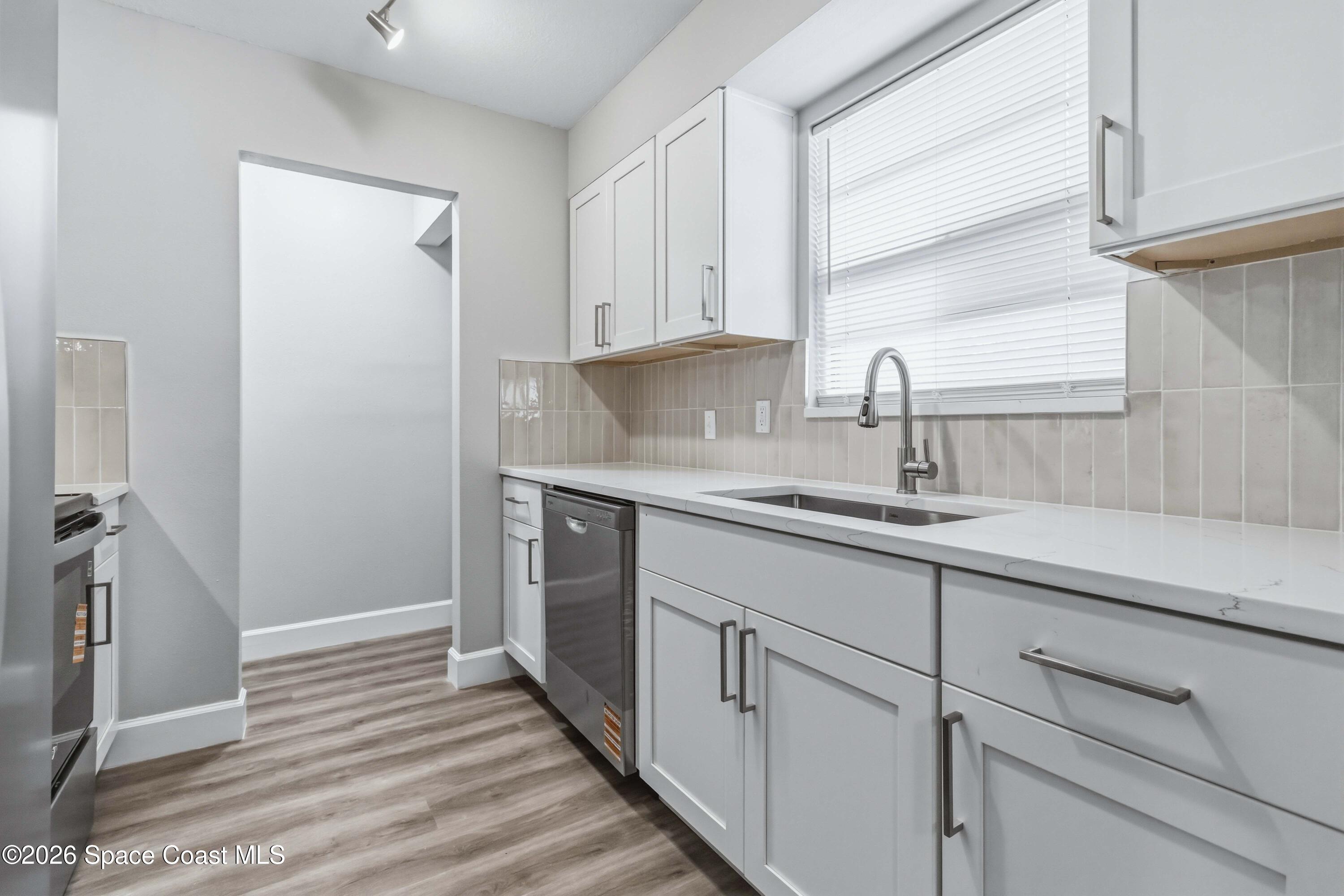 2258 Flower Tree Circle Melbourne, FL 32935 - Photo 10 of 30 a kitchen with a sink and cabinets