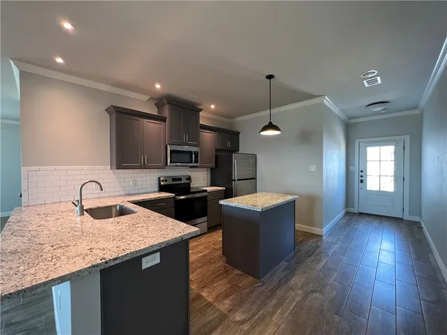 a kitchen with sink refrigerator and microwave