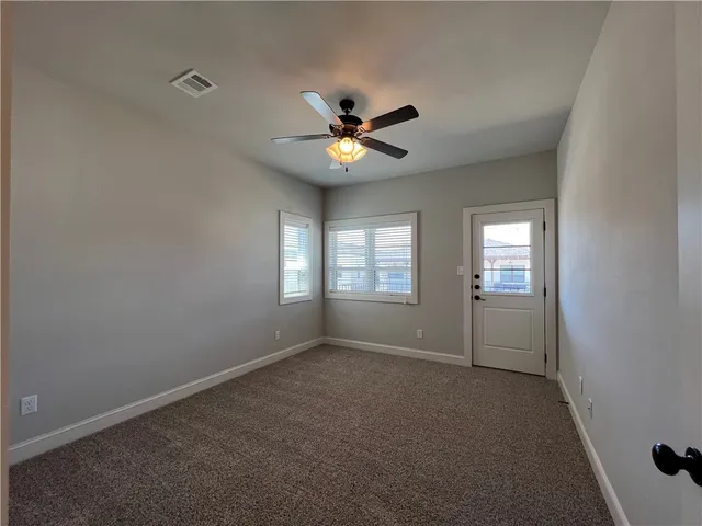 a view of room with a ceiling fan and window