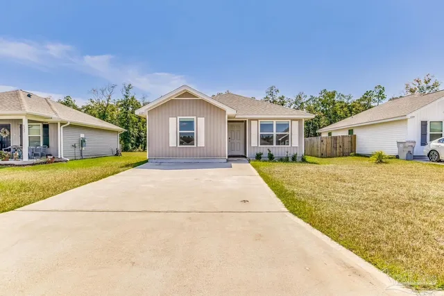 a front view of a house with a garden and plants