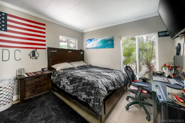 a bed sitting in a bedroom next to a window