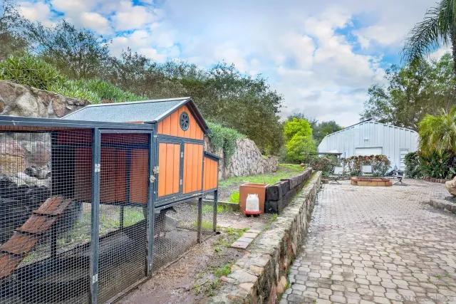 a view of backyard with deck and outdoor seating