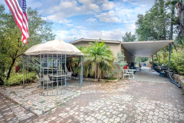 an outdoor space with furniture and umbrella