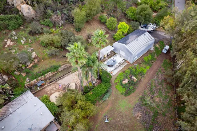 a view of a house with a yard and large tree