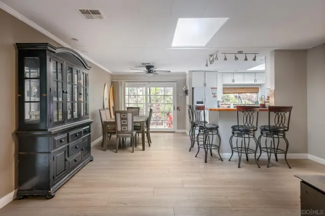 a view of dining room kitchen with furniture and chandelier