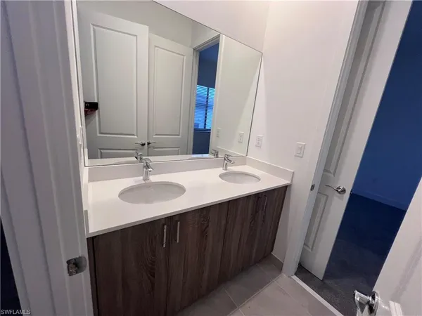 a hall with a sink cabinets and a wooden floor