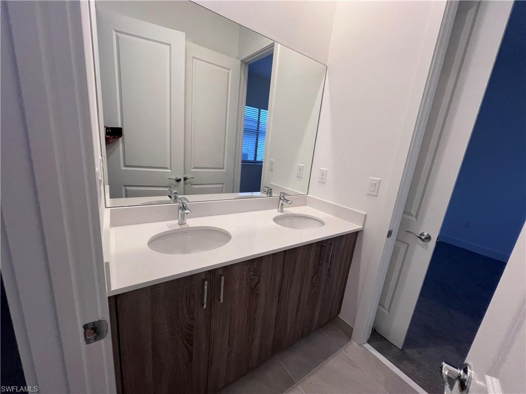 5261 Lamone Ln Avenue Immokalee, FL 34142 - Photo 9 of 14 Bathroom with vanity and tile patterned flooring
